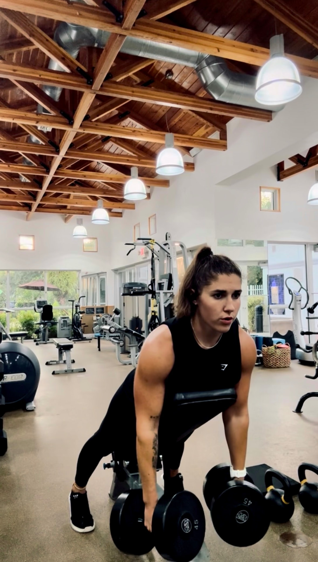 Athlete performing a dumbbell strength exercise in a training facility